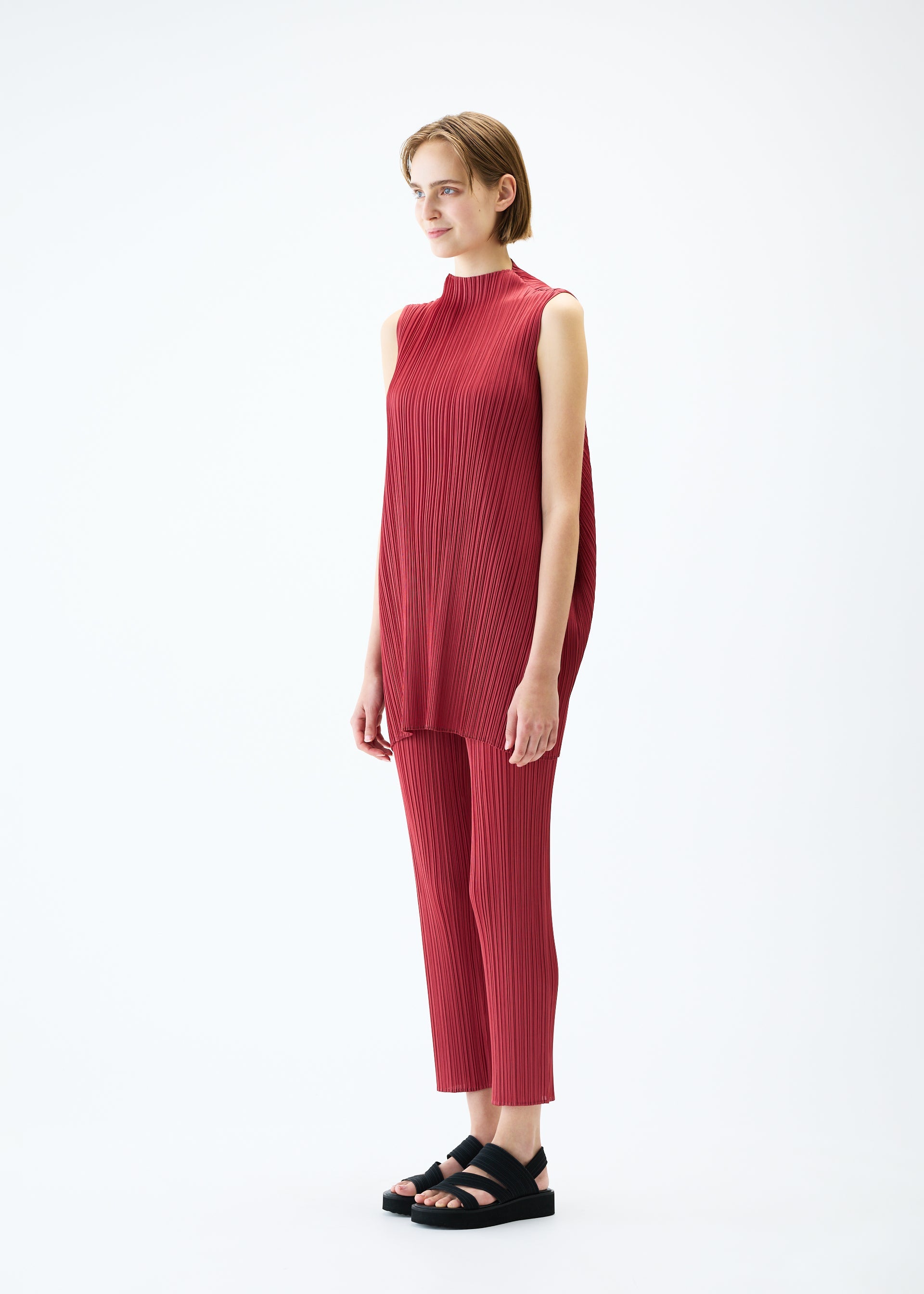 A model wears the PLEATS PLEASE ISSEY MIYAKE LAMP SHADE trousers.