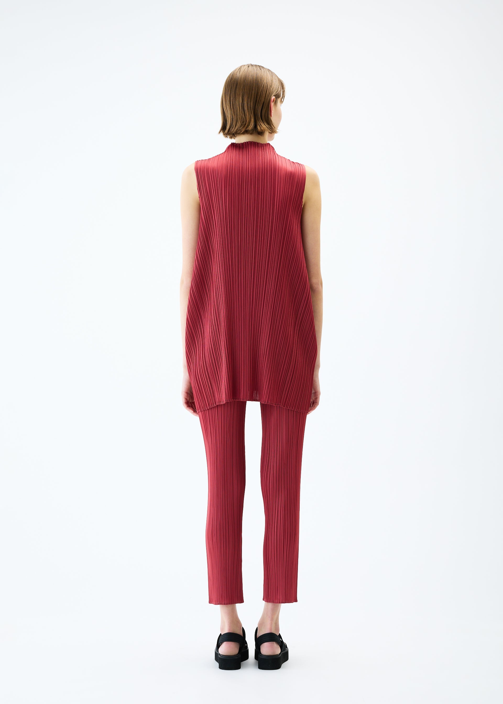 A model wears the PLEATS PLEASE ISSEY MIYAKE LAMP SHADE trousers.