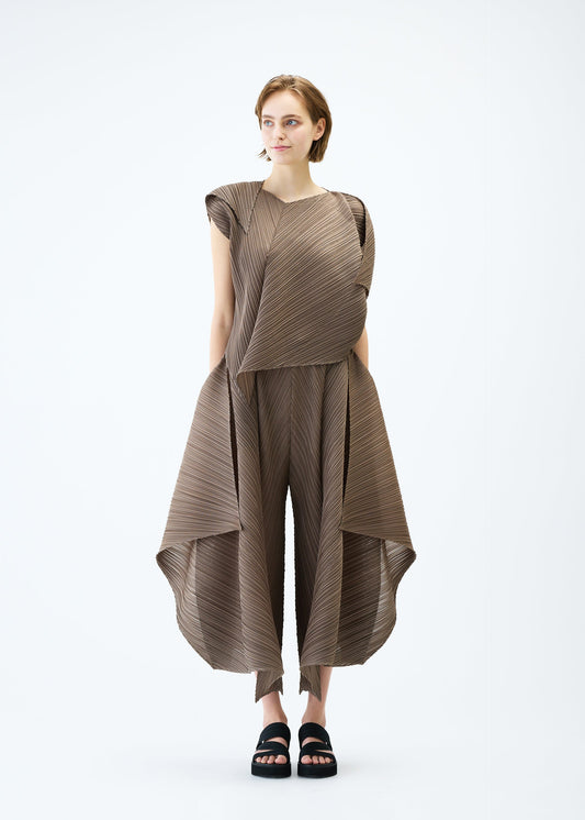 A model wears the PLEATS PLEASE ISSEY MIYAKE FLARE trousers.