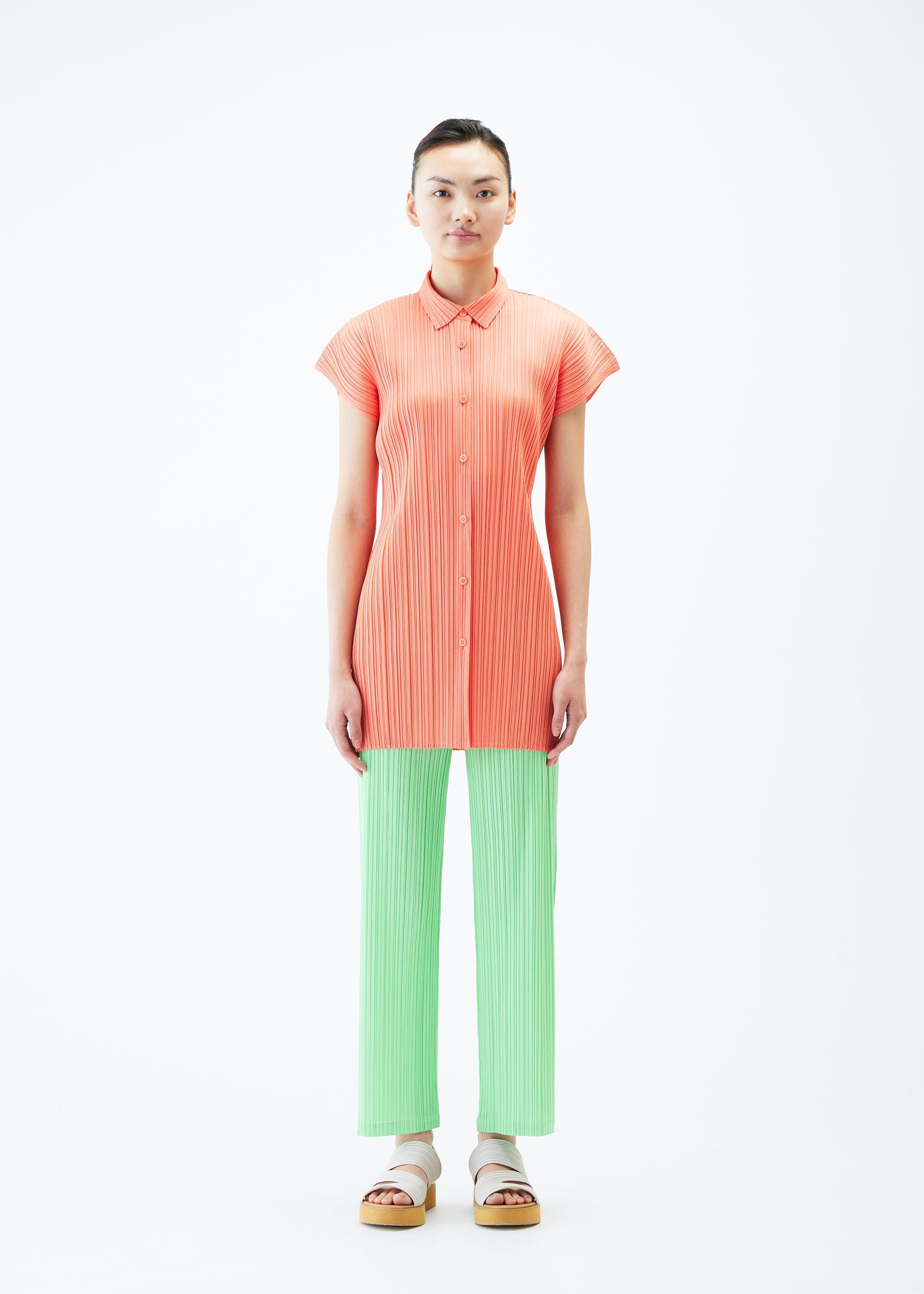 A model wears the PLEATS PLEASE ISSEY MIYAKE MONTHLY COLORS MAY shirt.