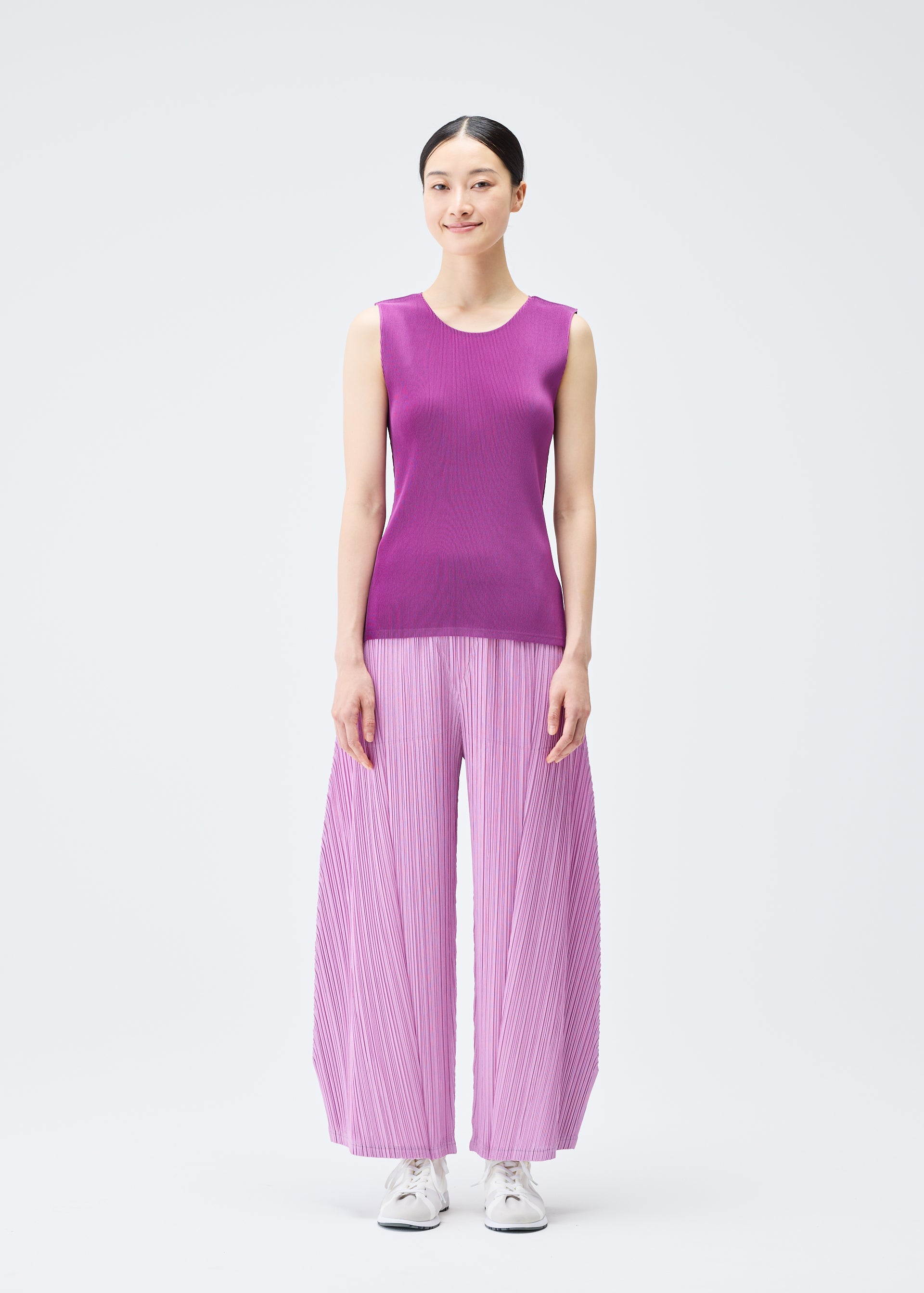 A model wears the Pleats Please Issey Miyake MIST SEPTEMBER top.