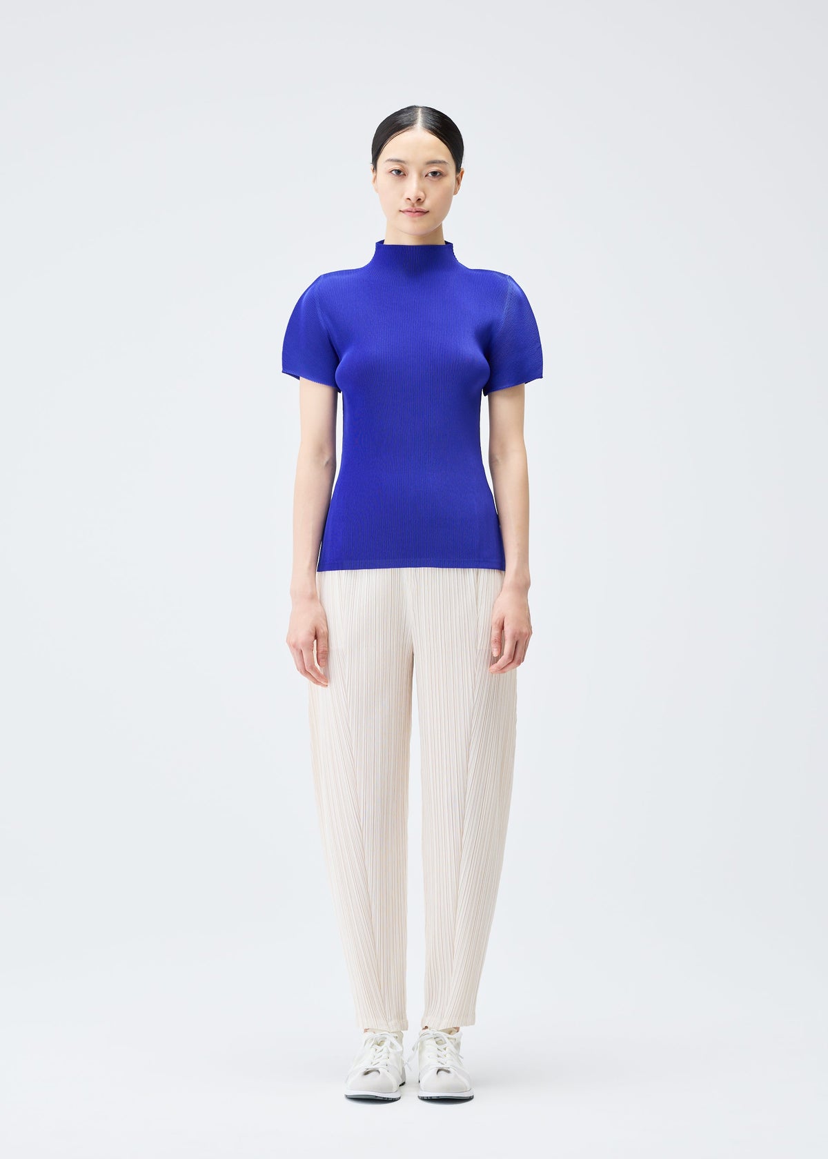 A model wears the Pleats Please Issey Miyake MIST SEPTEMBER top.