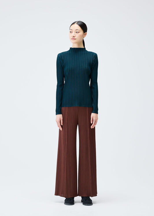 A model wears the Pleats Please Issey Miyake RIB PLEATS NOVEMBER shirt.