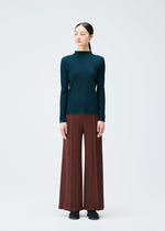 A model wears the Pleats Please Issey Miyake RIB PLEATS NOVEMBER shirt.