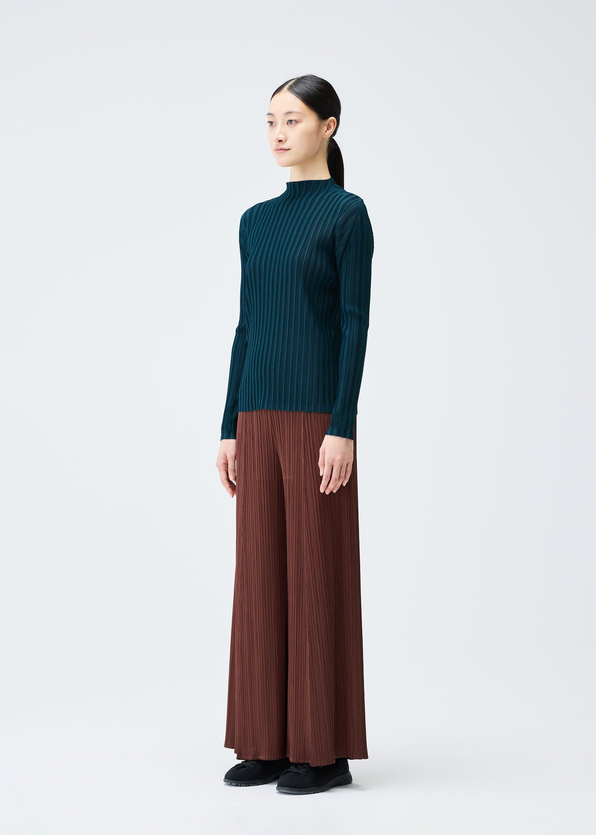 A model wears the Pleats Please Issey Miyake RIB PLEATS NOVEMBER shirt.