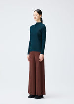 A model wears the Pleats Please Issey Miyake RIB PLEATS NOVEMBER shirt.