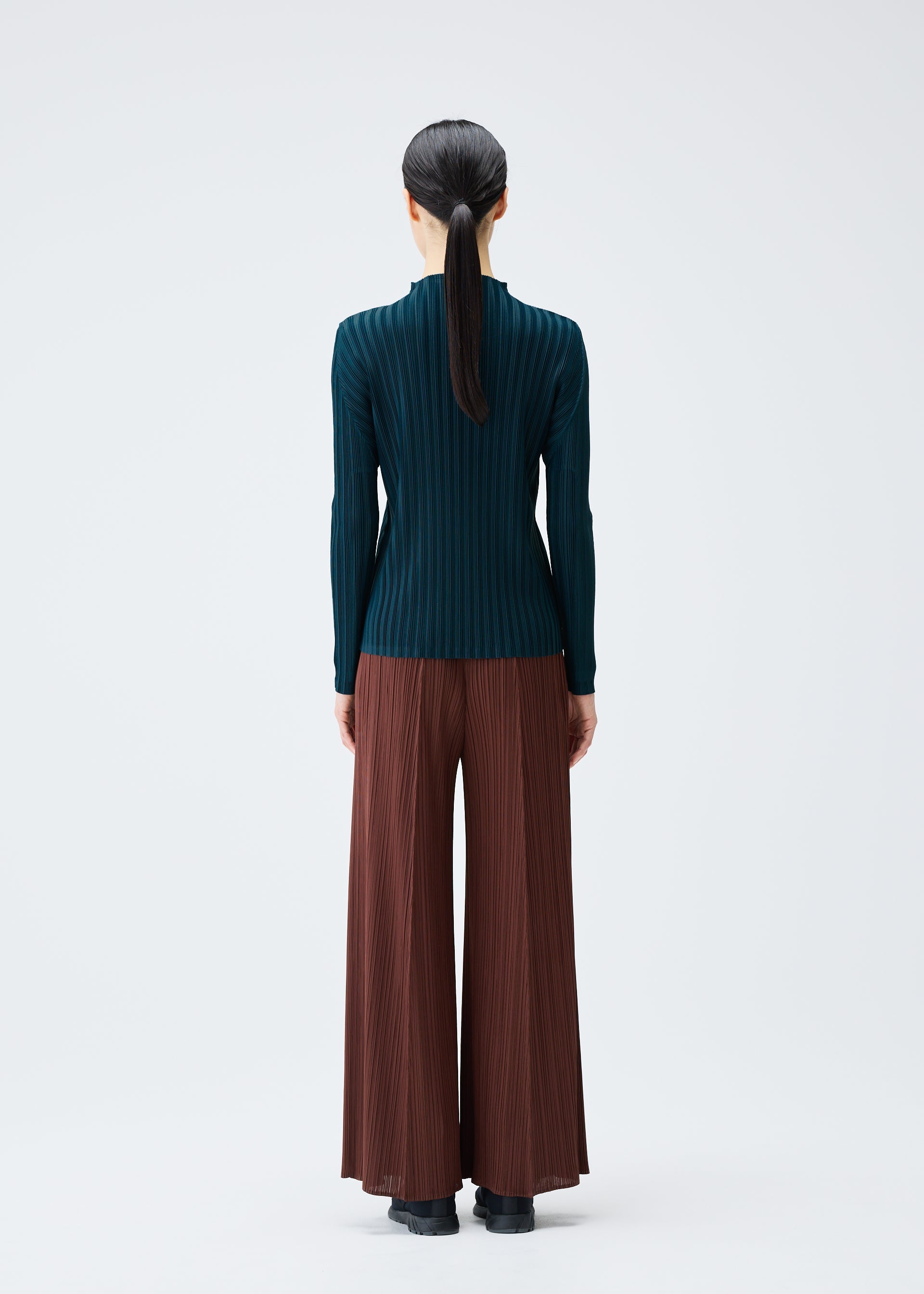 A model wears the Pleats Please Issey Miyake RIB PLEATS NOVEMBER shirt.