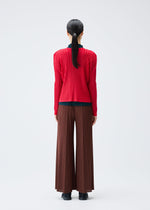 A model wears the Pleats Please Issey Miyake RIB PLEATS NOVEMBER cardigan.