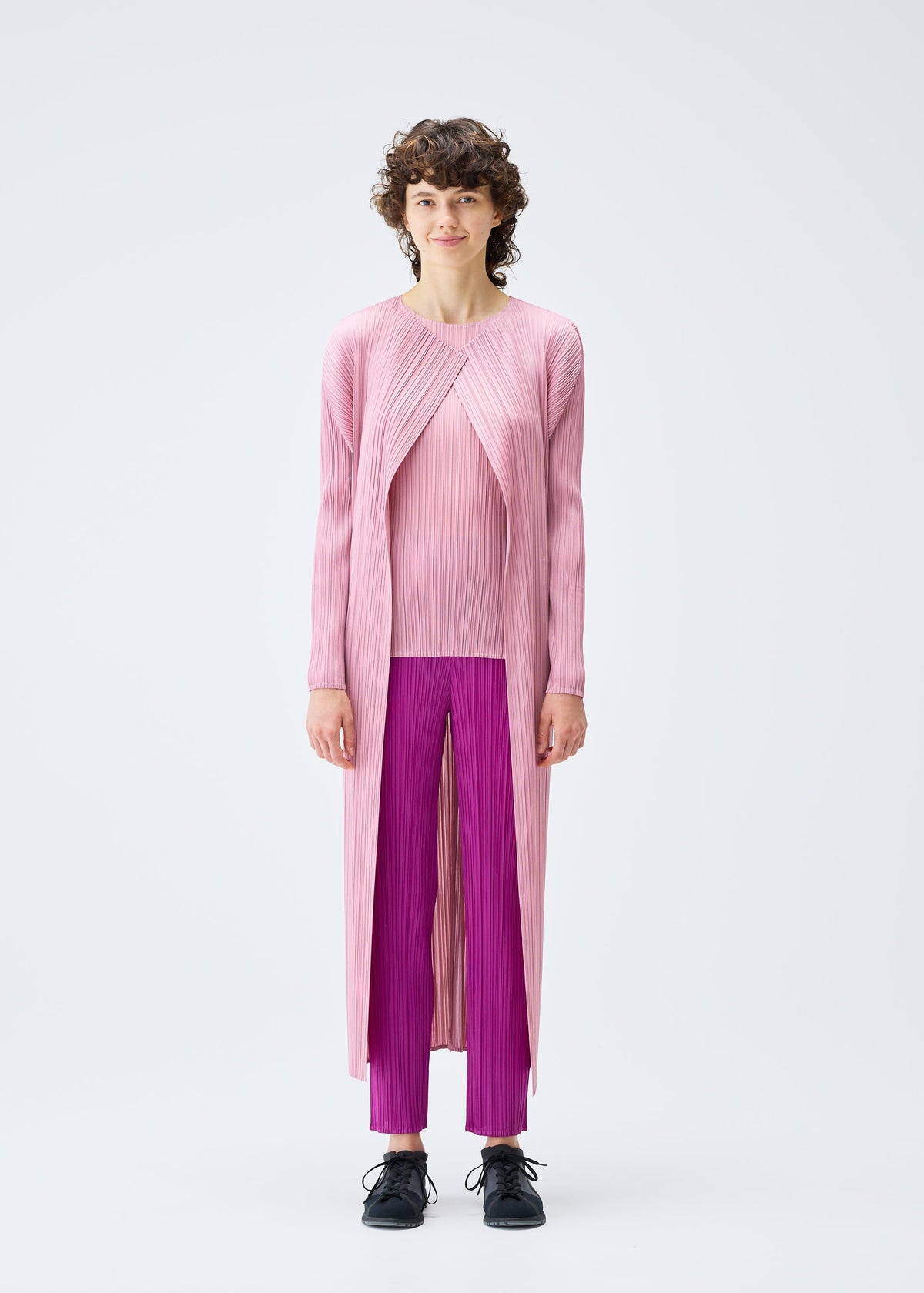 A model wears the Pleats Please Issey Miyake MONTHLY COLORS SEPTEMBER coat.