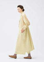 A model wears the Pleats Please Issey Miyake MONTHLY COLORS : DECEMBER coat.