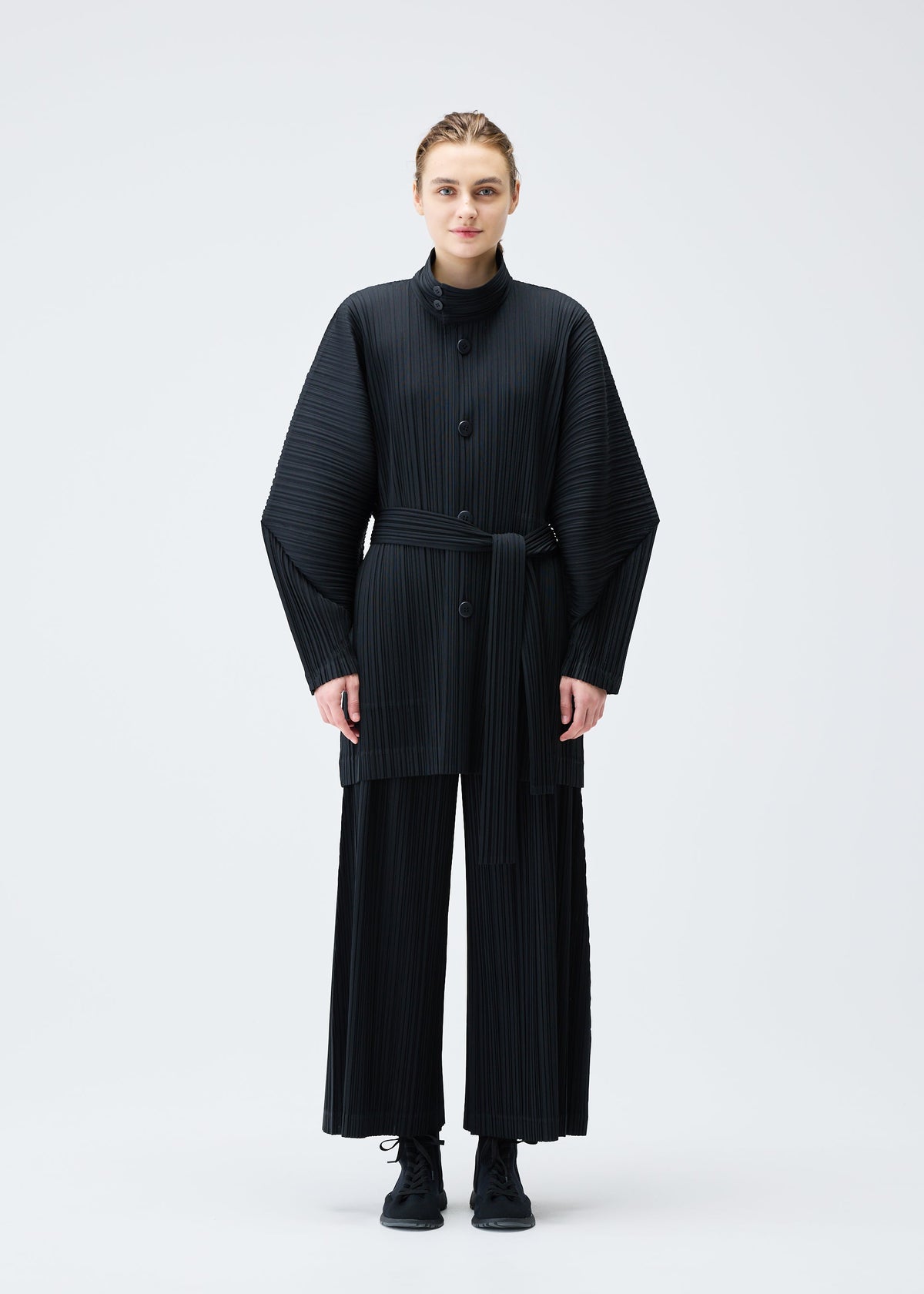 A model wears the Pleats Please Issey Miyake WOOL PLEATS coat.