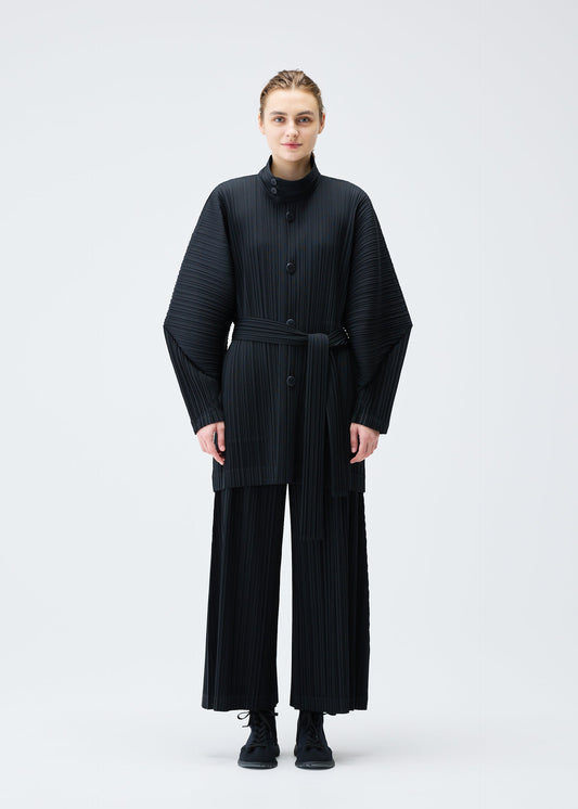 A model wears the Pleats Please Issey Miyake WOOL PLEATS coat.