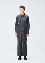A model wears the PLEATS PLEASE ISSEY MIYAKE COTTON DENIM coat.