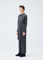 A model wears the PLEATS PLEASE ISSEY MIYAKE COTTON DENIM coat.