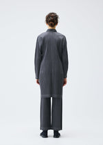 A model wears the PLEATS PLEASE ISSEY MIYAKE COTTON DENIM coat.