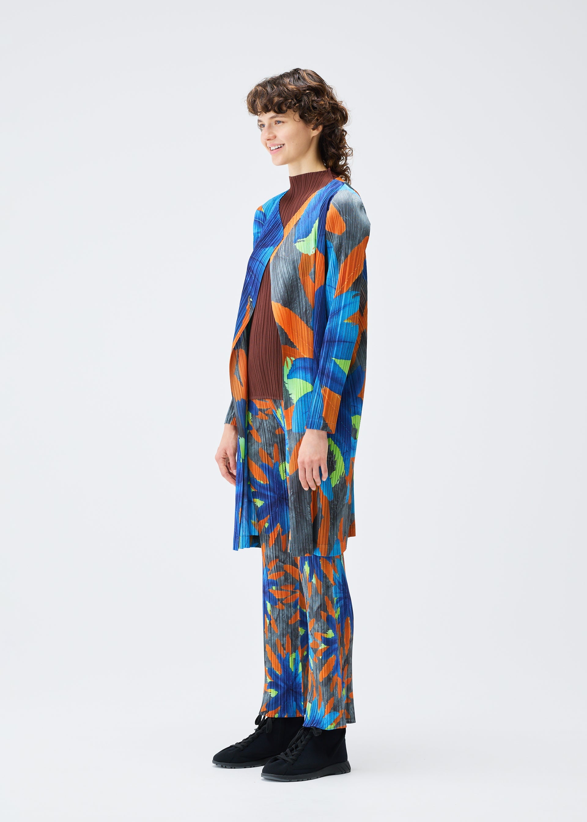 A model wears the Pleats Please Issey Miyake CARNIVAL coat.
