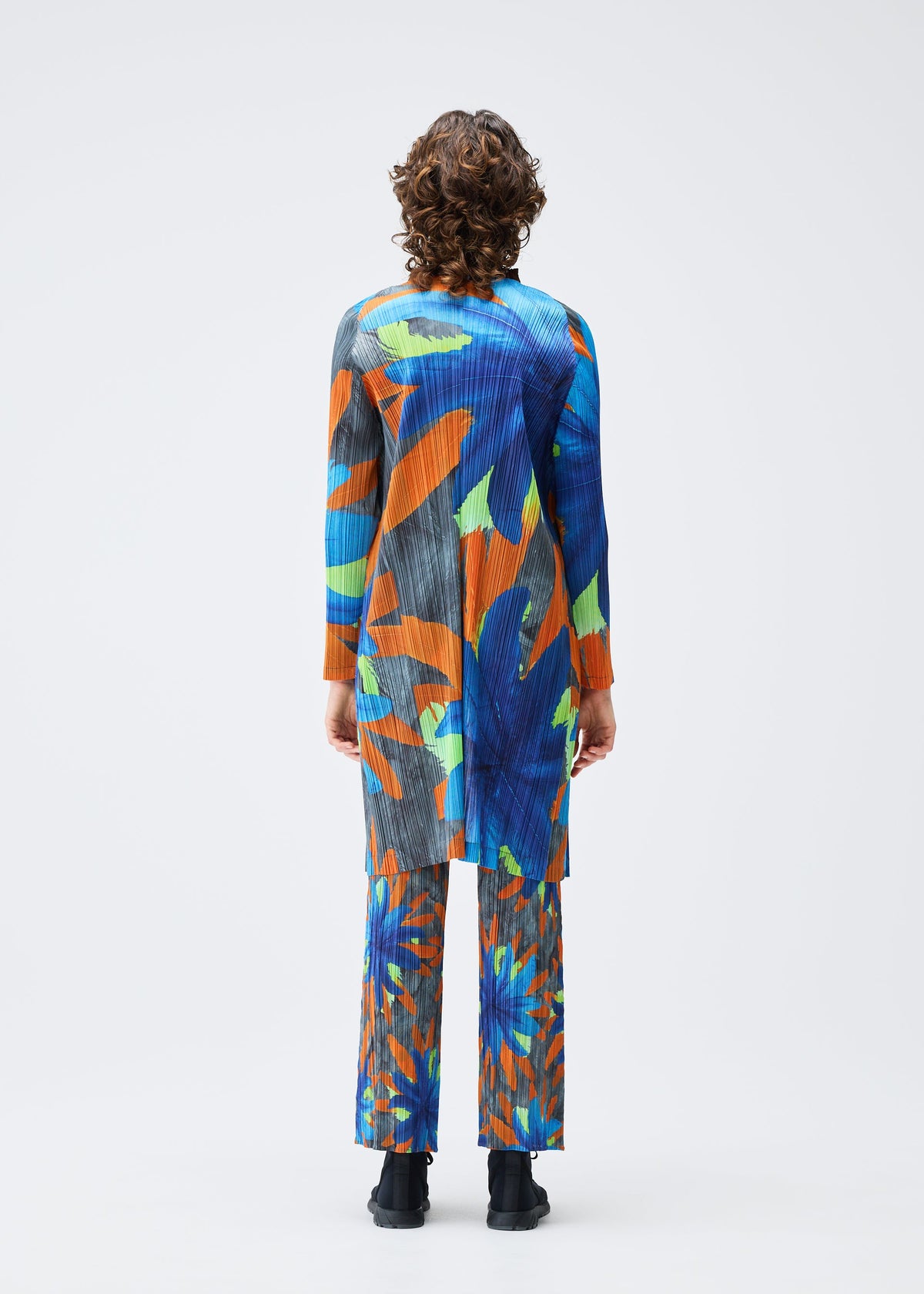 A model wears the Pleats Please Issey Miyake CARNIVAL coat.
