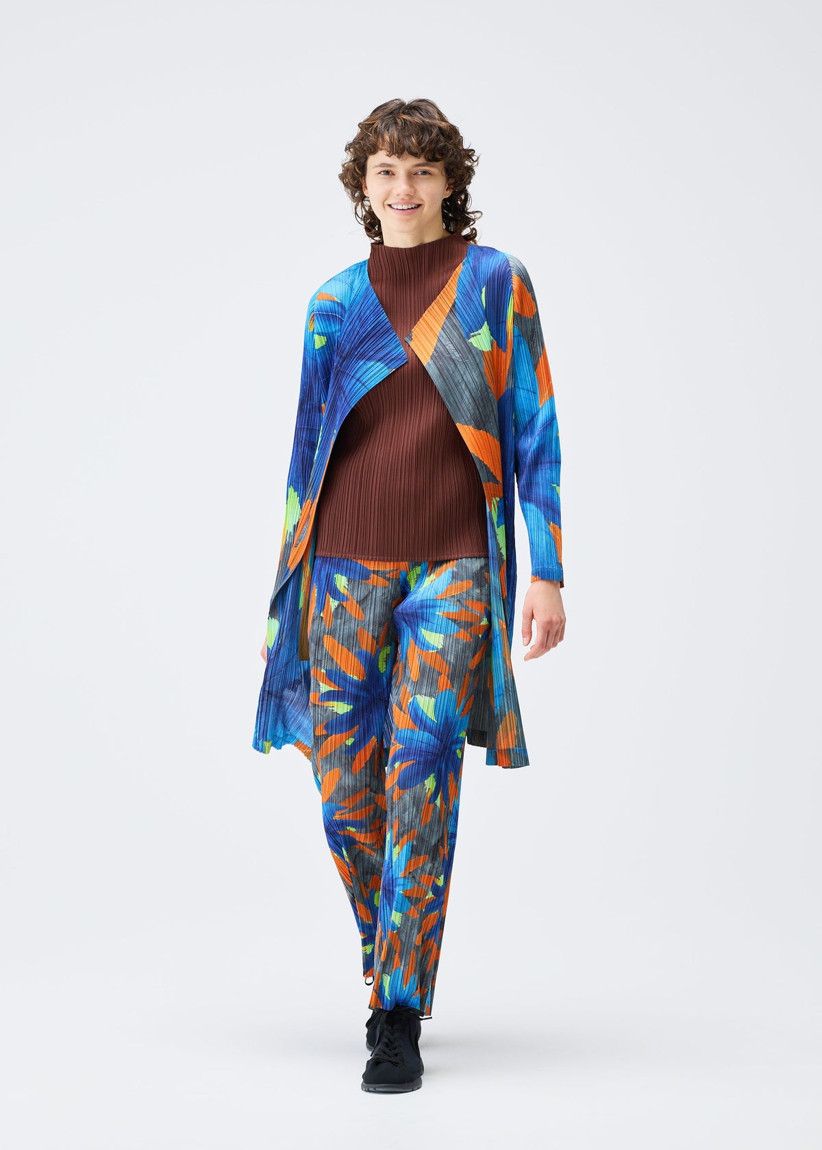 A model wears the Pleats Please Issey Miyake CARNIVAL coat.