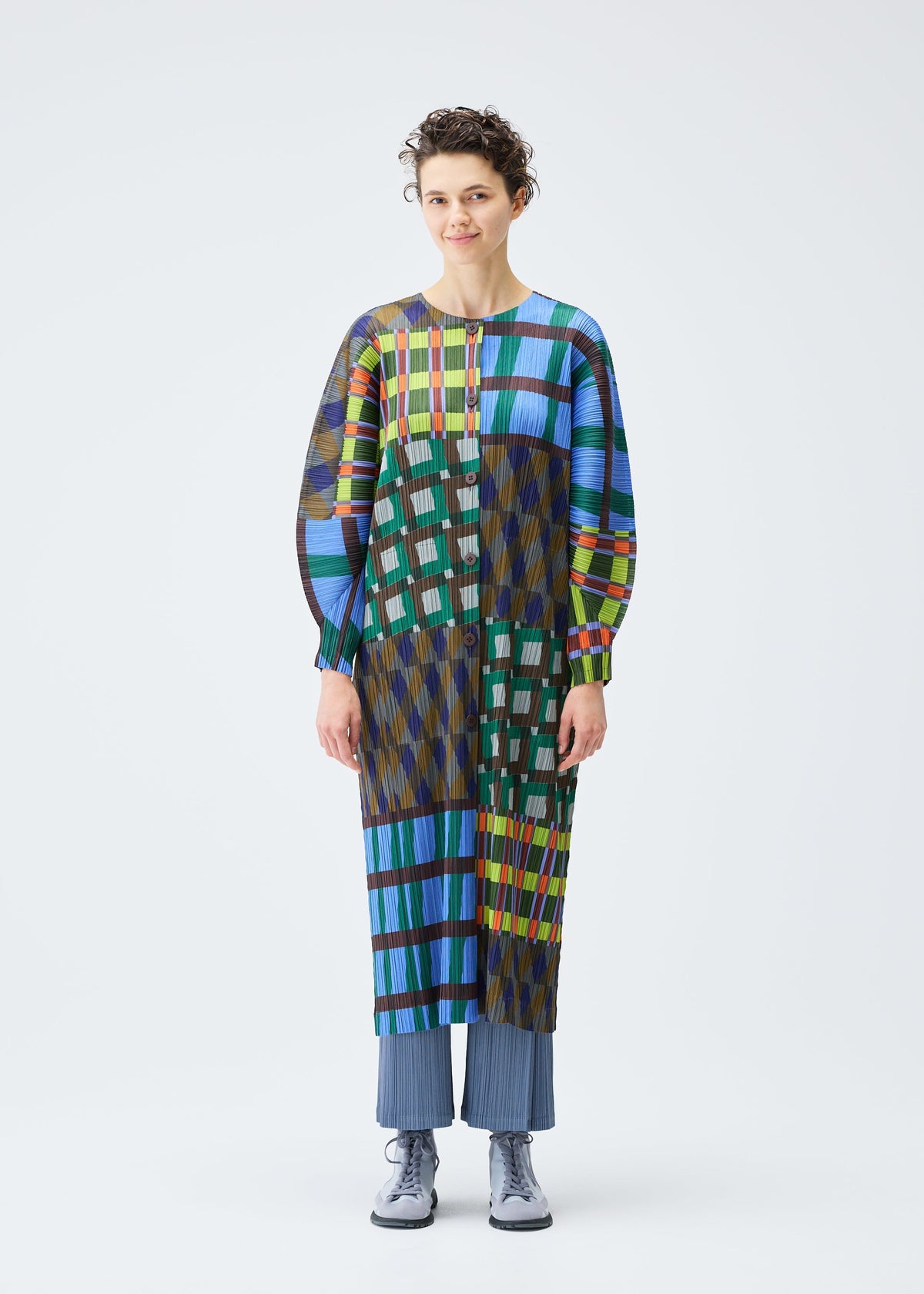 A model wears the Pleats Please Issey Miyake HARMONY coat.