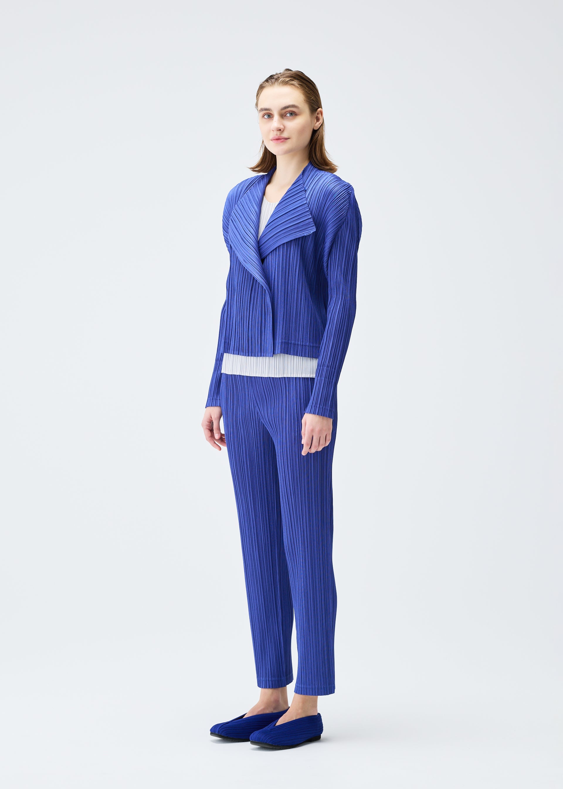 A model wears the Pleats Please Issey Miyake PLEATS JACKET jacket.