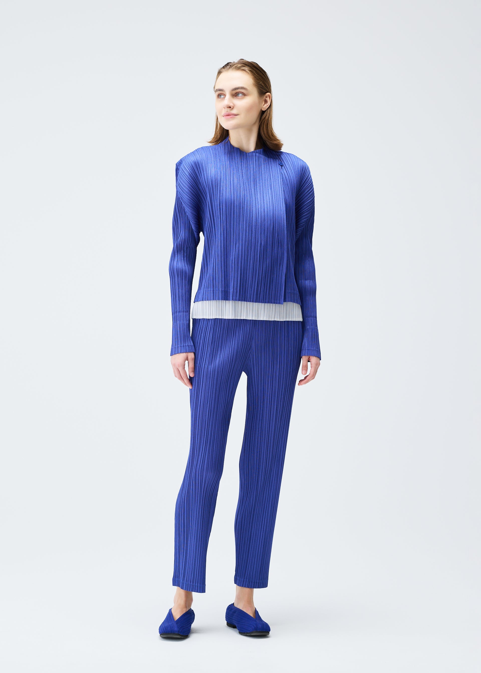 A model wears the Pleats Please Issey Miyake PLEATS JACKET jacket.