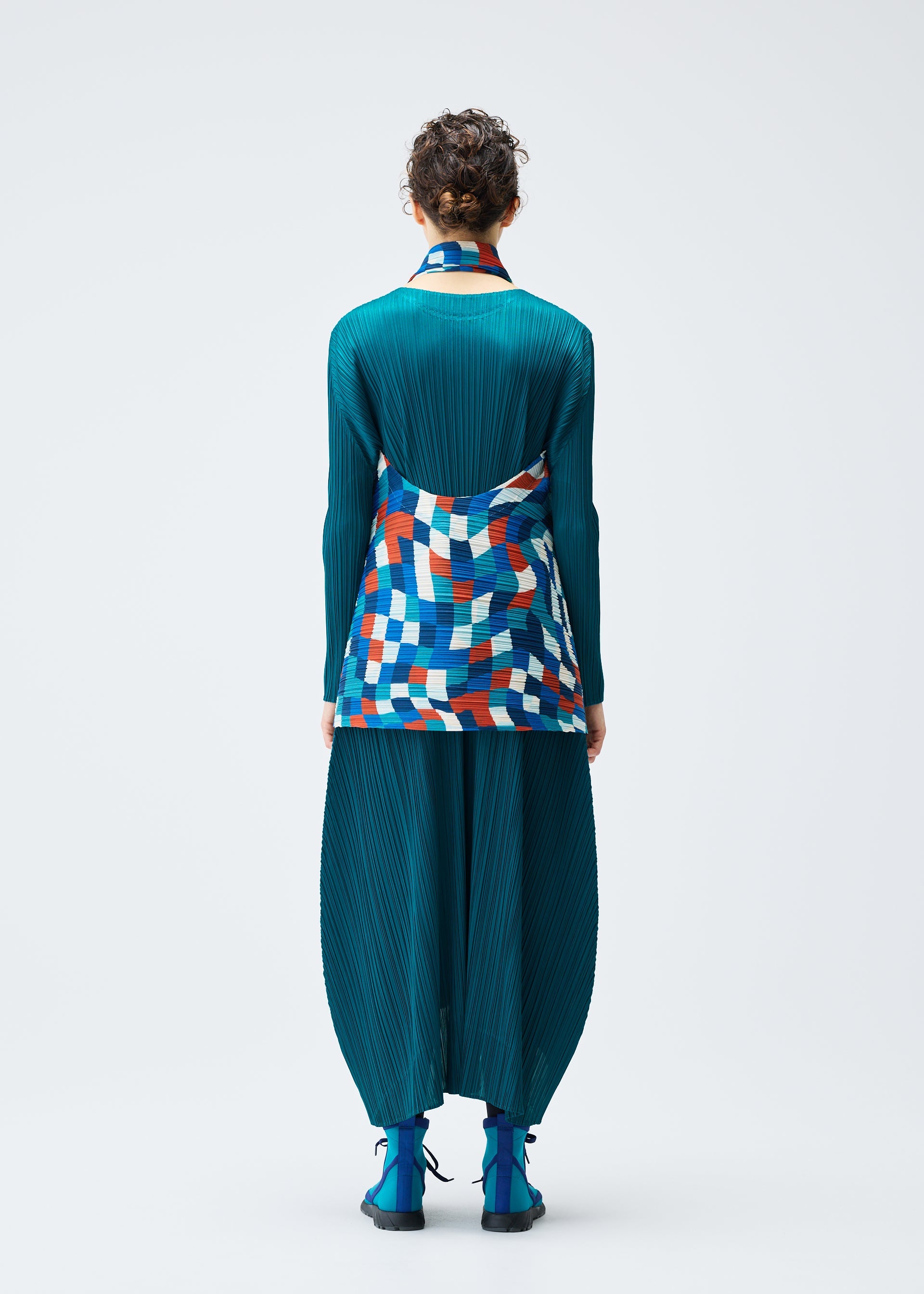 A model wears the PLEATS PLEASE ISSEY MIYAKE DANCING SQUARE vest.