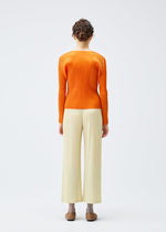 A model wears the Pleats Please Issey Miyake MONTHLY COLORS : DECEMBER trousers.