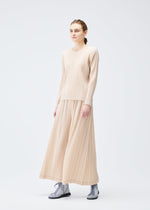A model wears the Pleats Please Issey Miyake WOOL PLEATS trousers.