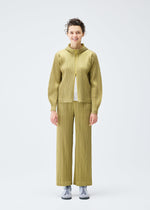 A model wears the PLEATS PLEASE ISSEY MIYAKE COTTON DENIM trousers.