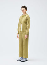 A model wears the PLEATS PLEASE ISSEY MIYAKE COTTON DENIM trousers.