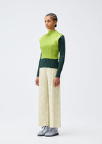 A model wears the Pleats Please Issey Miyake TUNE trousers.