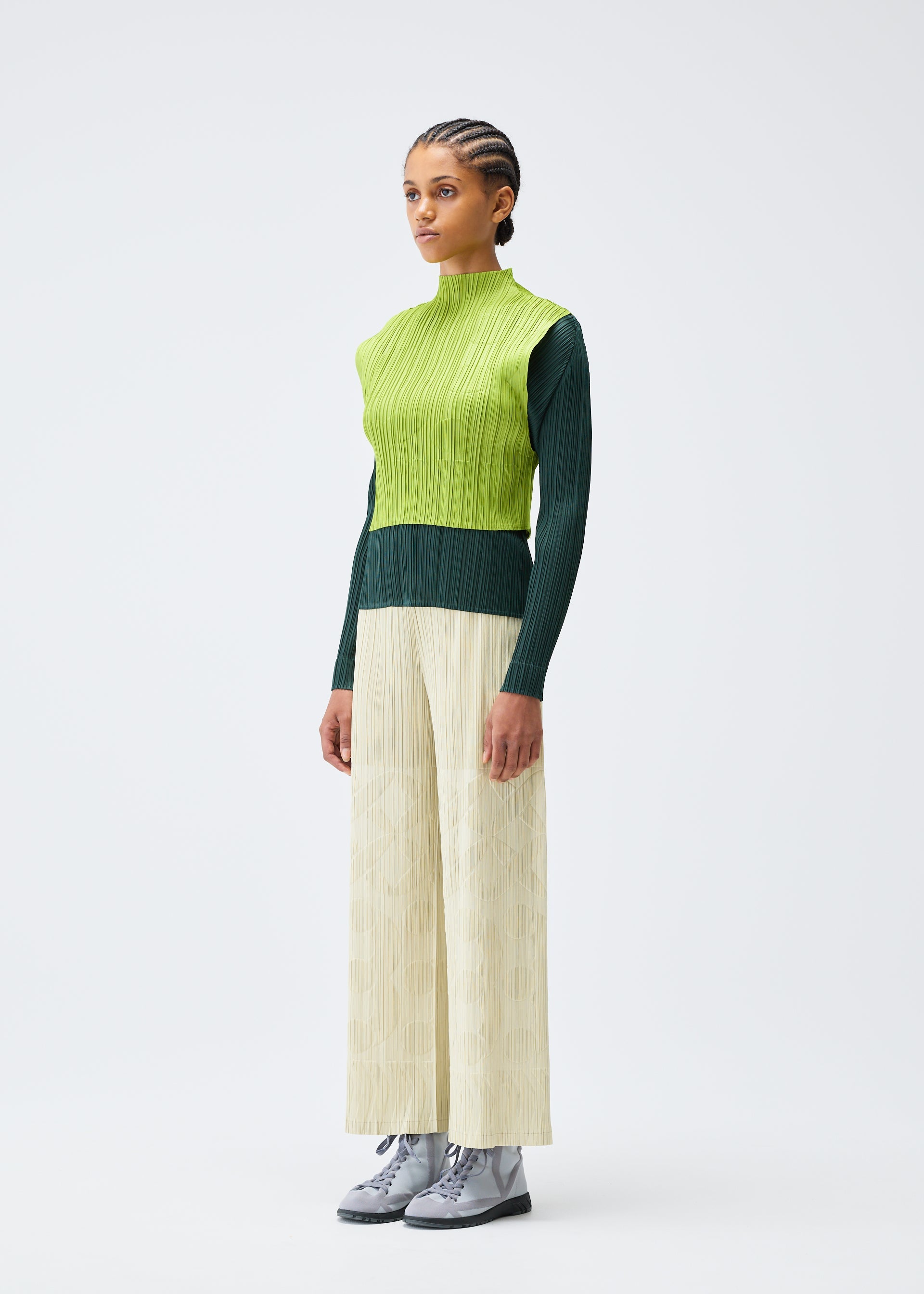 A model wears the Pleats Please Issey Miyake TUNE trousers.