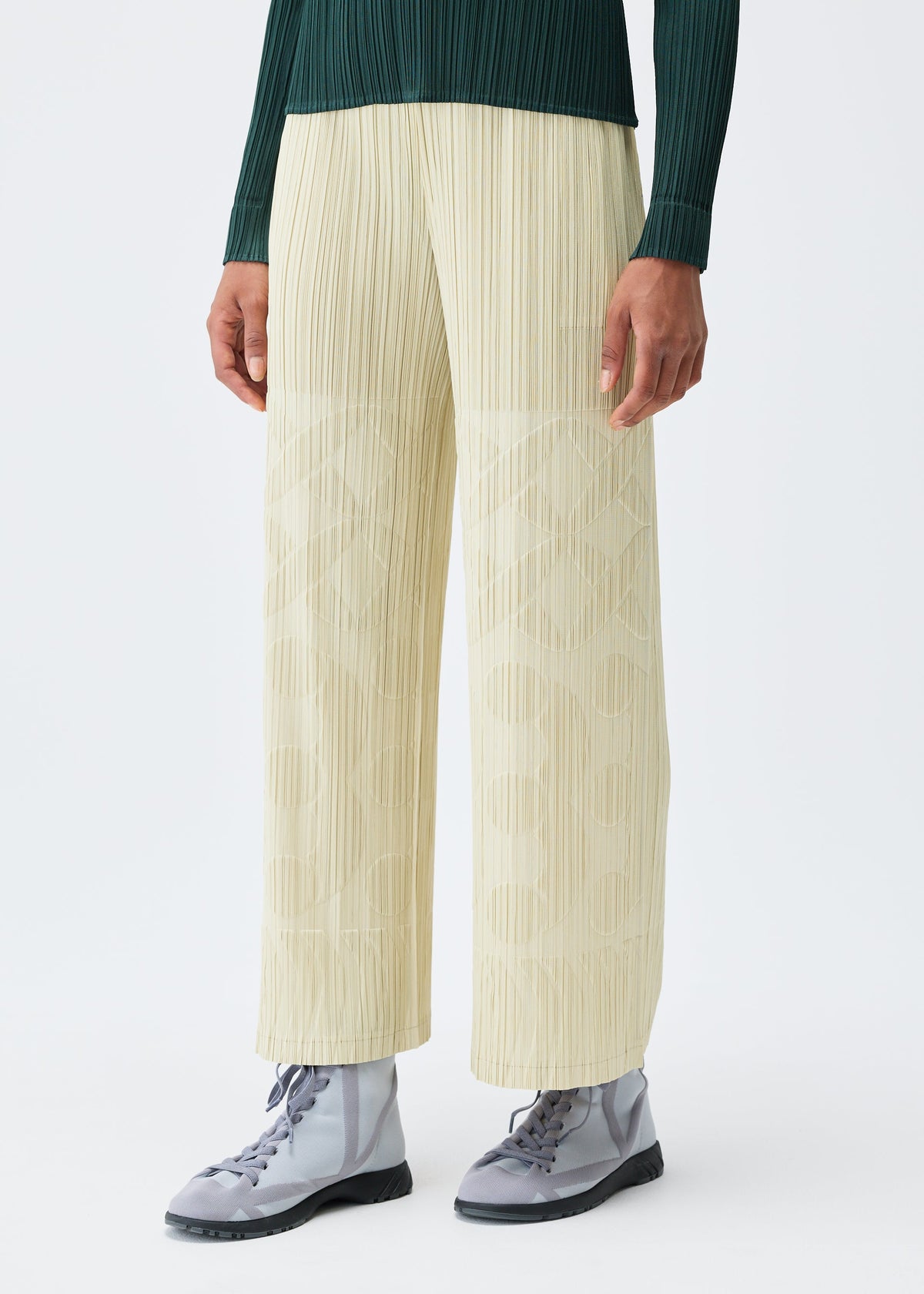 A model wears the Pleats Please Issey Miyake TUNE trousers.