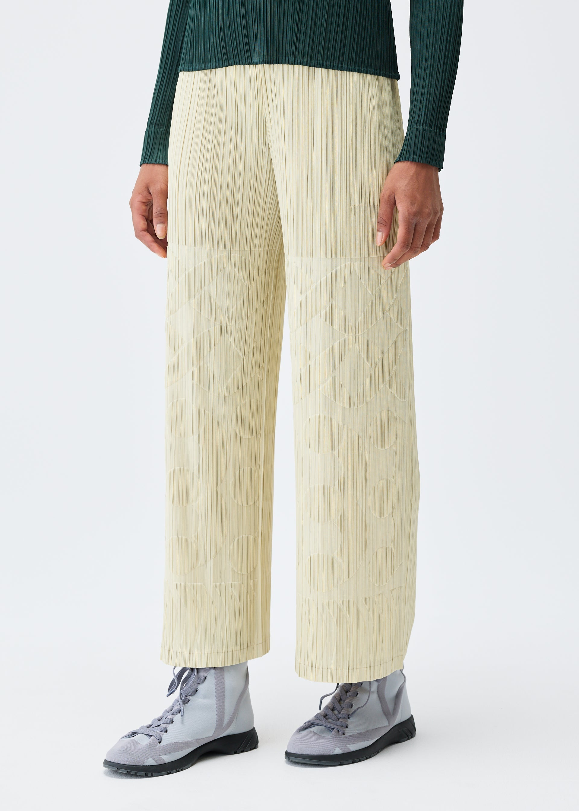 A model wears the Pleats Please Issey Miyake TUNE trousers.