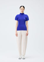 A model wears the Pleats Please Issey Miyake THICKER BOTTOMS 2 trousers.