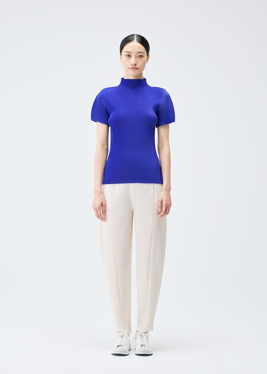 A model wears the Pleats Please Issey Miyake THICKER BOTTOMS 2 trousers.