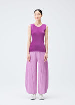 A model wears the Pleats Please Issey Miyake THICKER BOTTOMS 2 trousers.