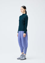A model wears the Pleats Please Issey Miyake THICKER BOUNCE trousers.