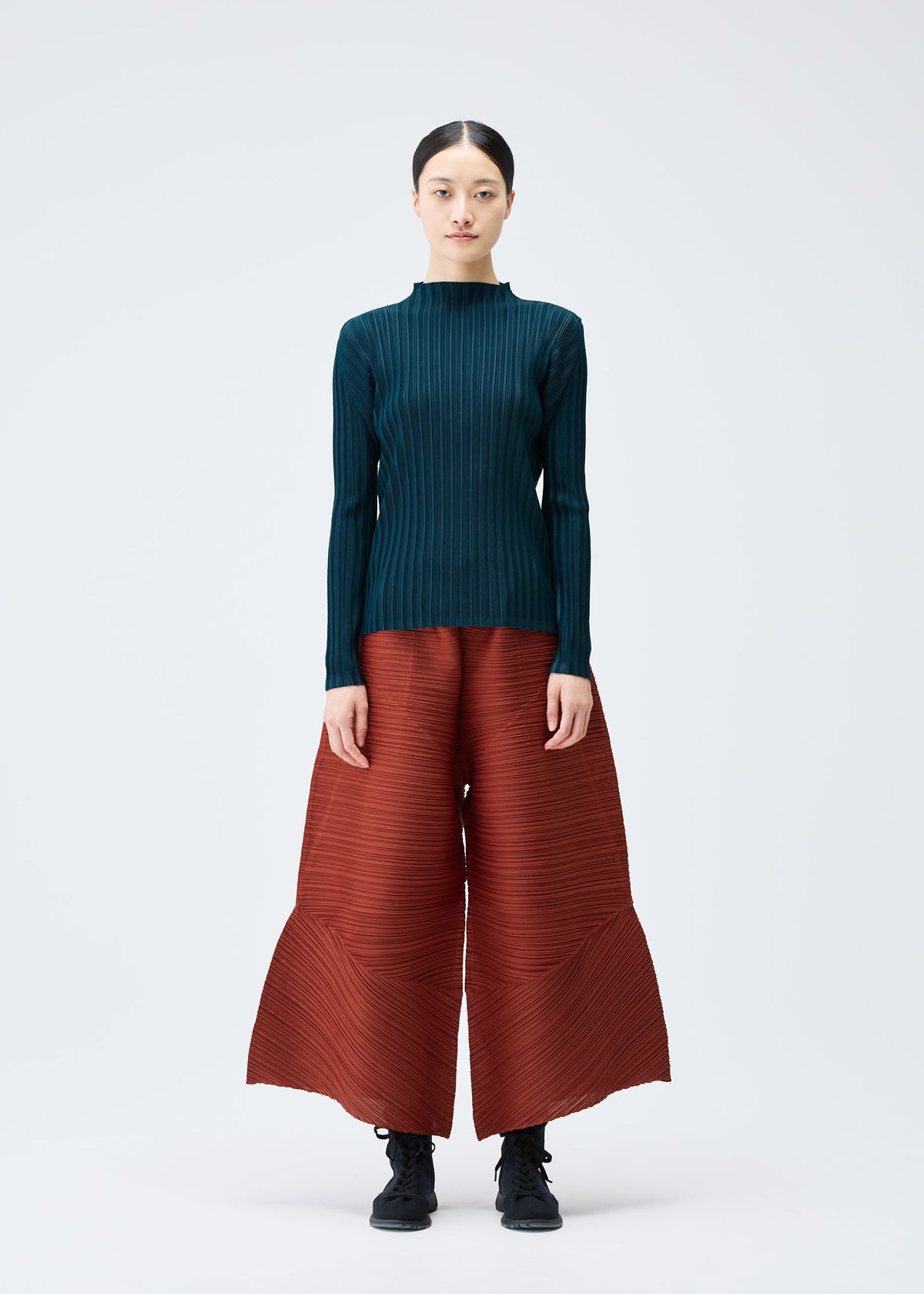 A model wears the Pleats Please Issey Miyake THICKER BOUNCE trousers.