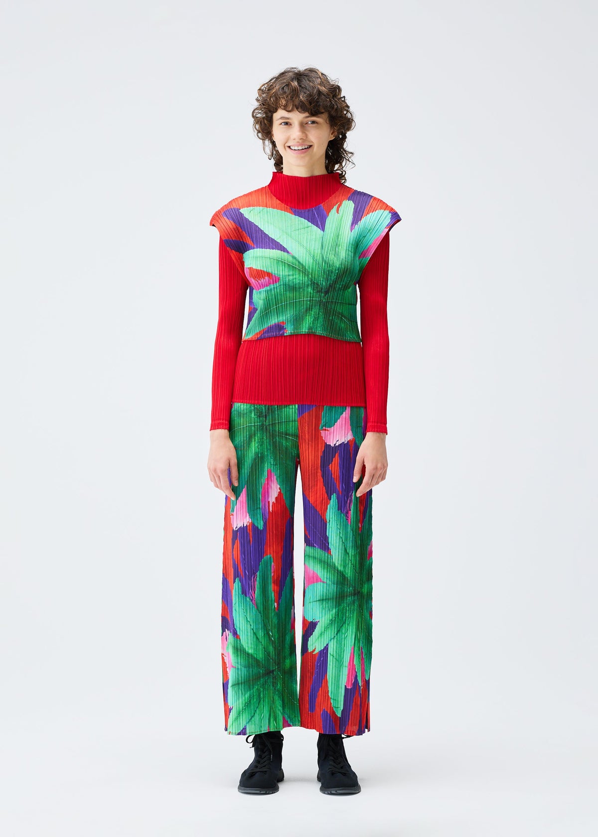 A model wears the Pleats Please Issey Miyake CARNIVAL trousers.