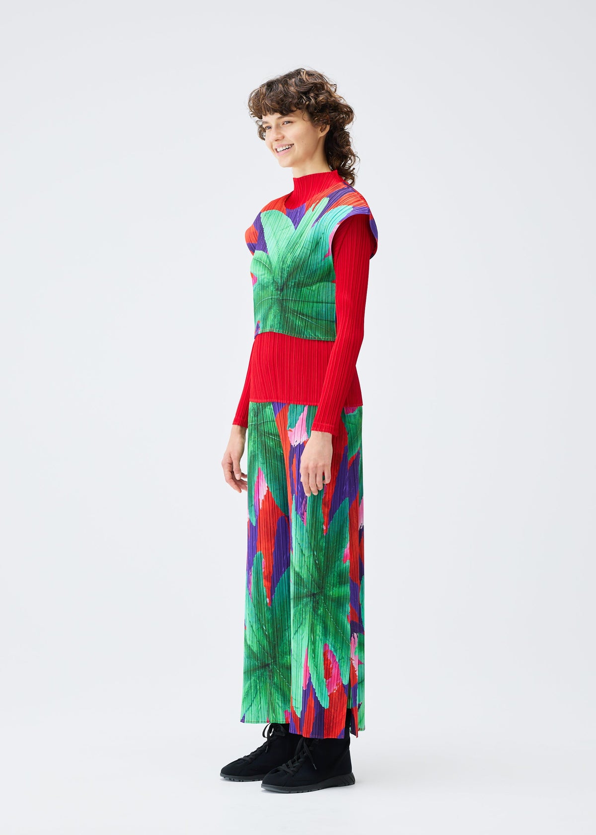 A model wears the Pleats Please Issey Miyake CARNIVAL trousers.
