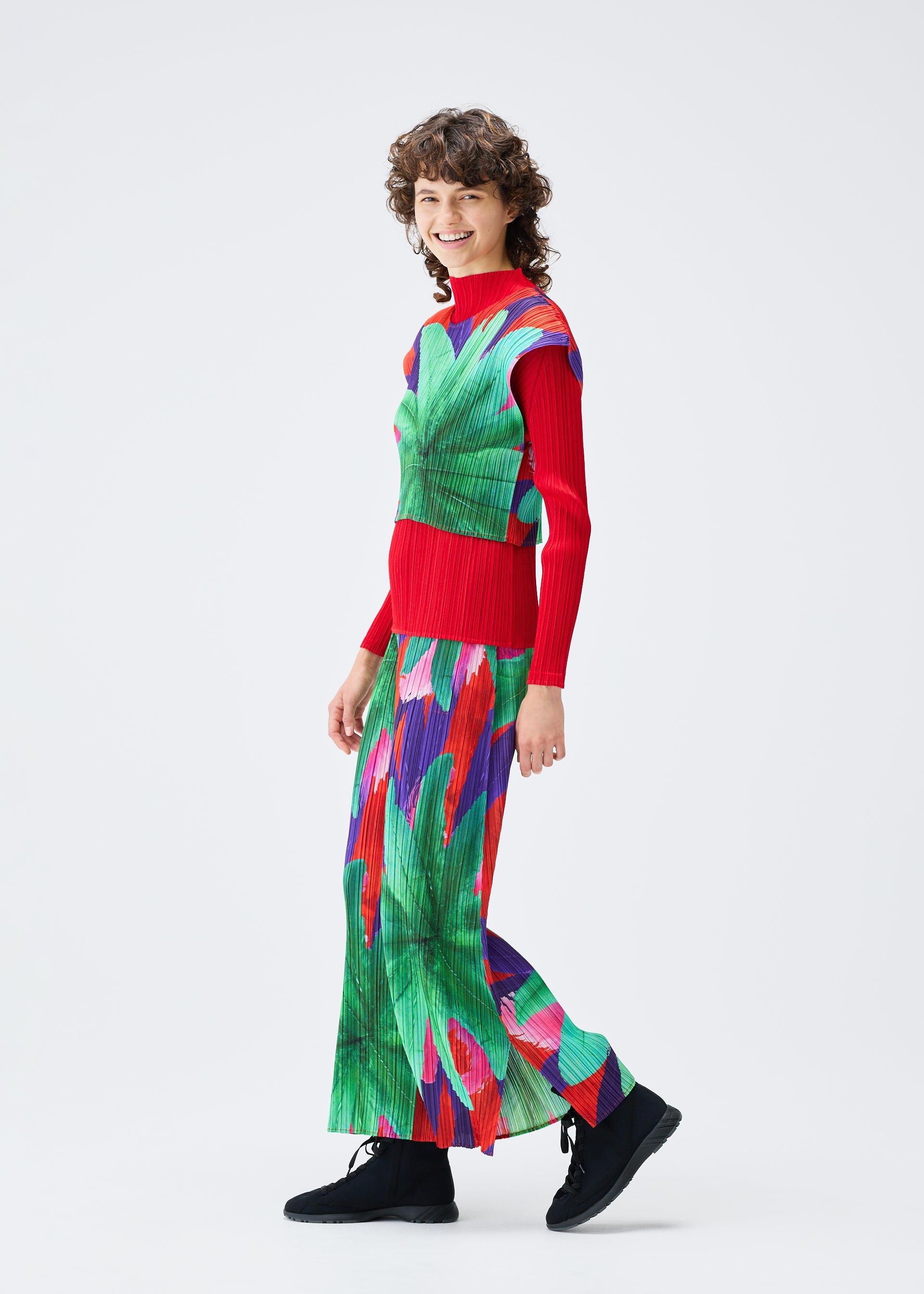 A model wears the Pleats Please Issey Miyake CARNIVAL trousers.