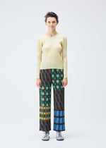 A model wears the Pleats Please Issey Miyake HARMONY trousers.