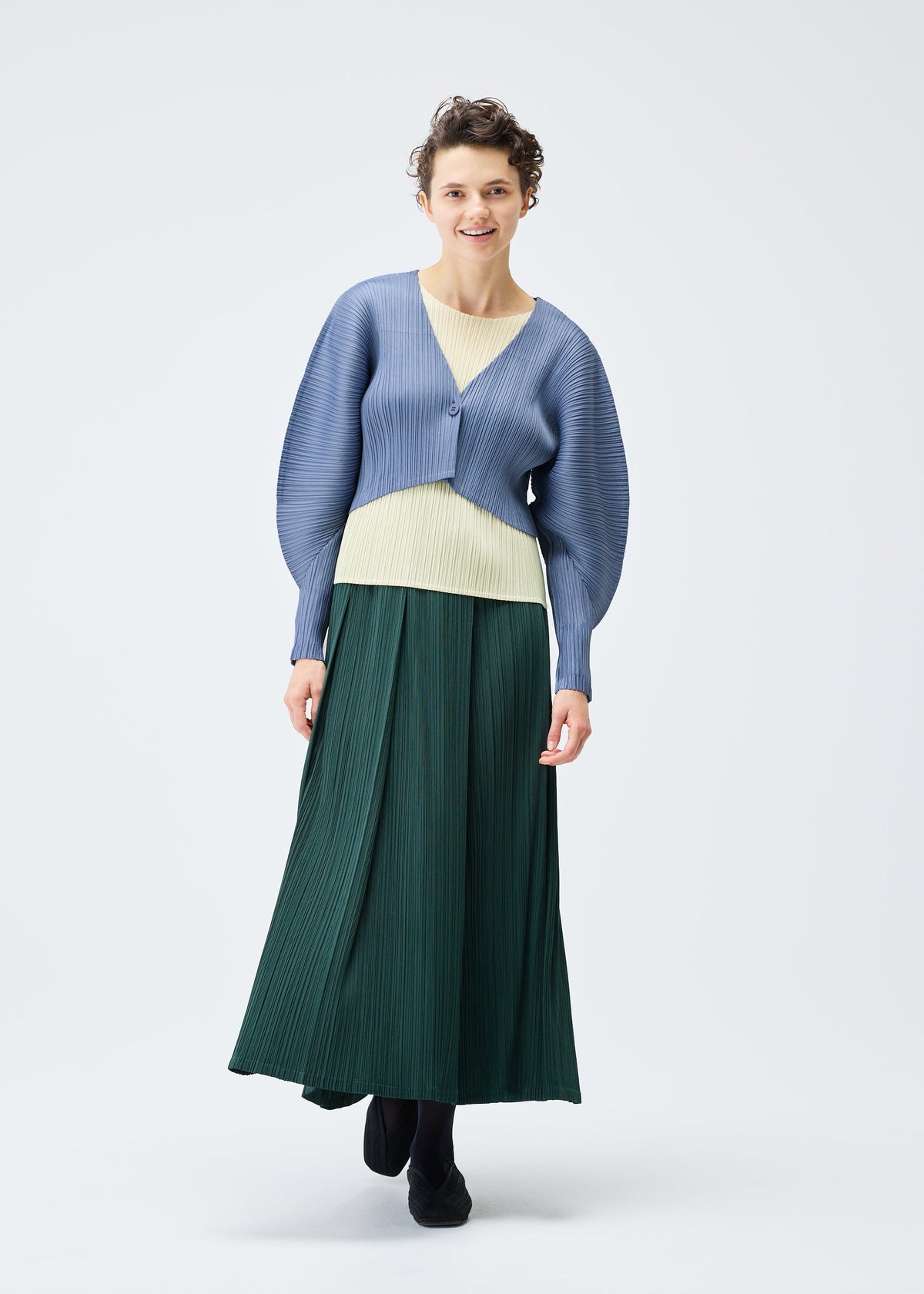A model wears the Pleats Please Issey Miyake MONTHLY COLORS : DECEMBER skirt.
