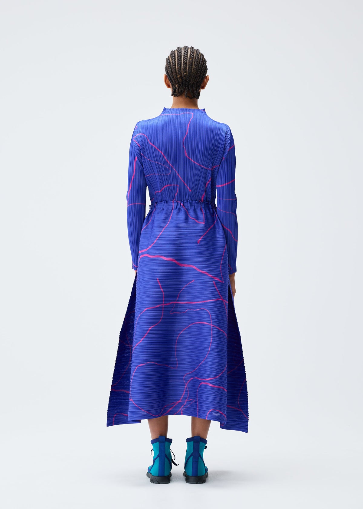 A model wears the Pleats Please Issey Miyake PAUSE skirt.