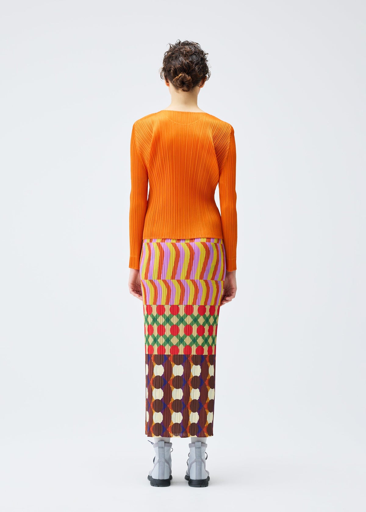 A model wears the Pleats Please Issey Miyake HARMONY skirt.