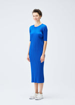 A model wears the PLEATS PLEASE ISSEY MIYAKE MONTHLY COLORS AUGUST dress.