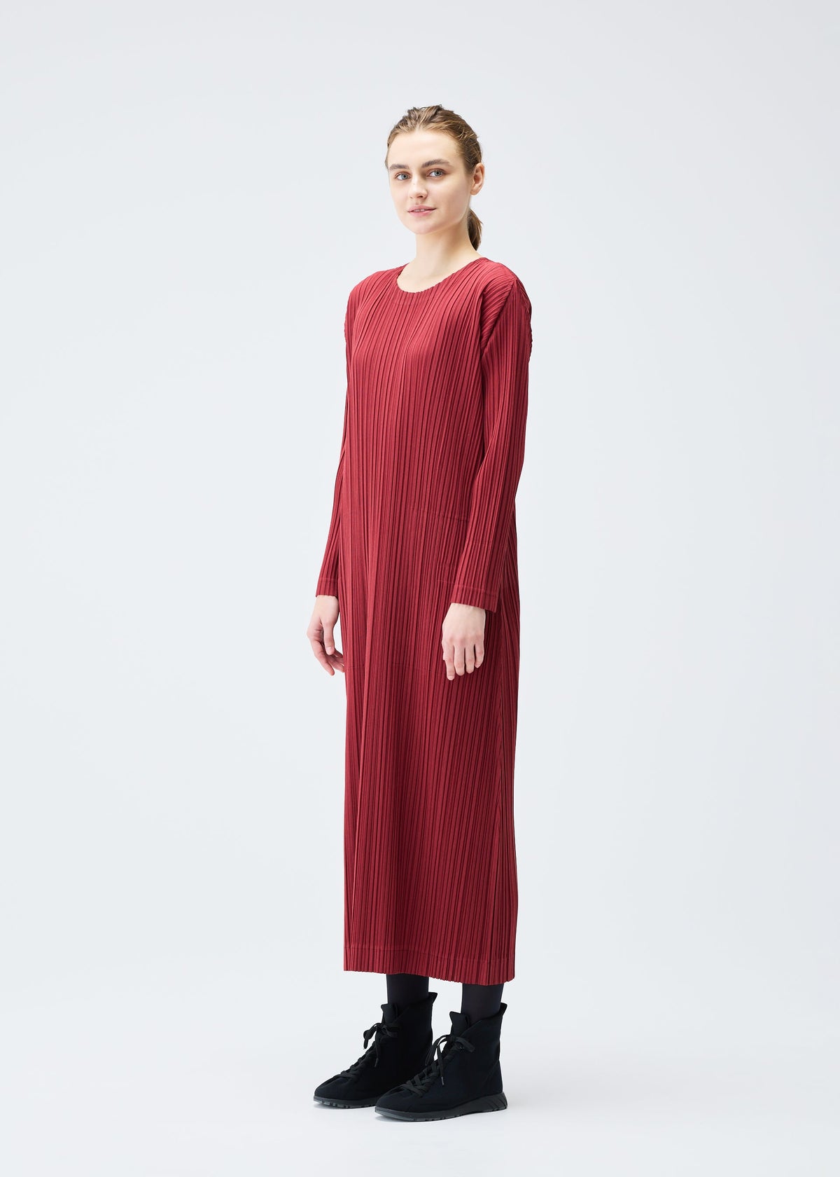 A model wears the Pleats Please Issey Miyake WOOL PLEATS dress.