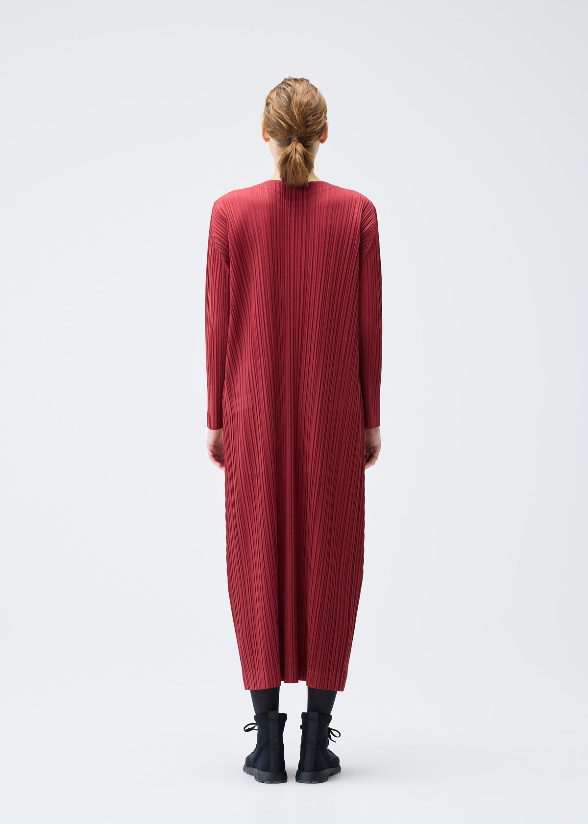 A model wears the Pleats Please Issey Miyake WOOL PLEATS dress.