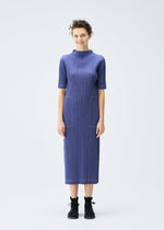 A model wears the PLEATS PLEASE ISSEY MIYAKE COTTON DENIM dress.